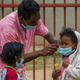 Face masks are placed on children in Antananarivo, Madagascar, on Oct. 3, 2017. (Alexander Joe/AP Images)